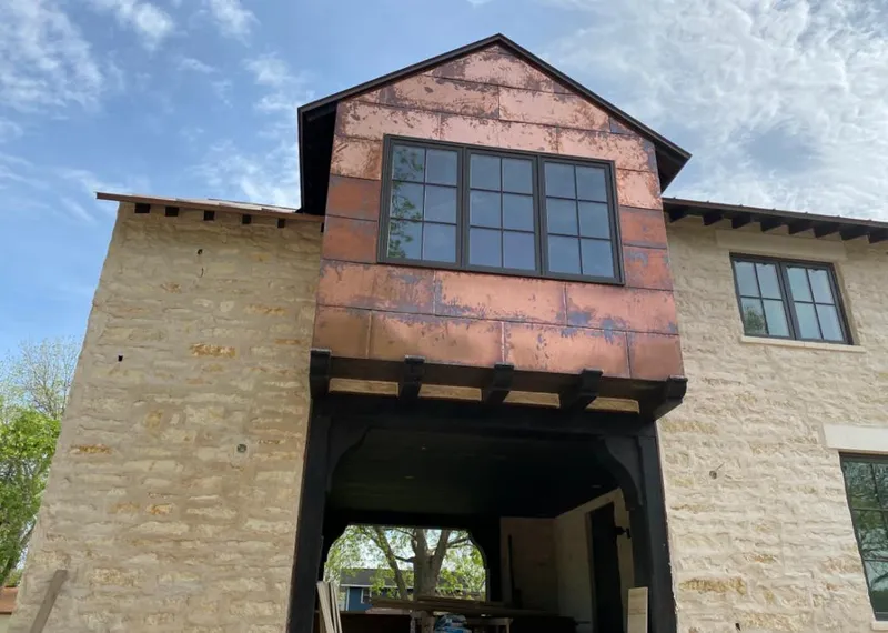 Copper metal panel facade on a stone building for Metal Roof Coating in Phelps
