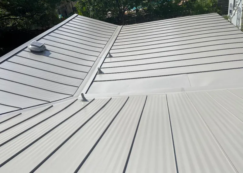 Solar attic fan installed on a metal roof for Roof Ventilation in Phelps